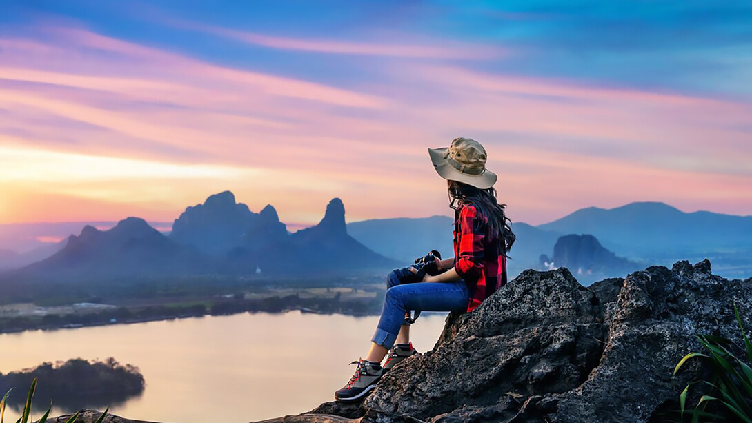 Tourist sitting on Phu sub lek viewpoint at sunset Lopburi Thailand