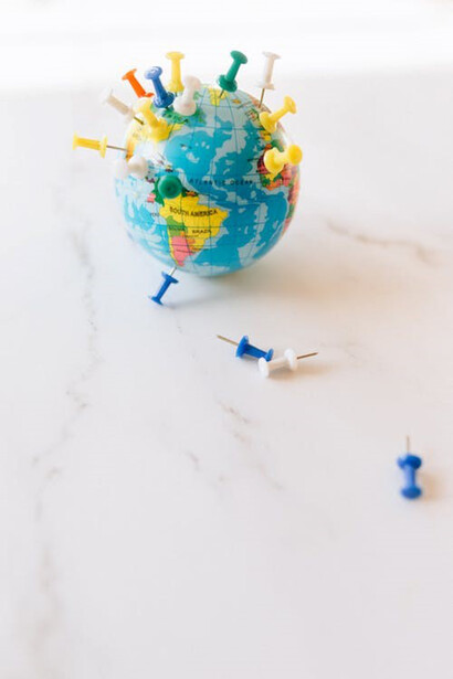 Picture of a globe with pins attached to it