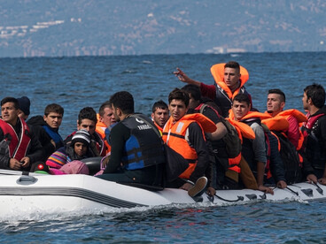 Migrants traveling in an inflatable boat from Turkey toward Greece in search of safety