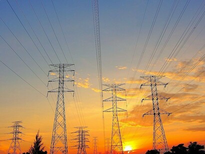 An extensive electrical grid against the setting sun, reflecting the importance of protecting energy networks in the age of artificial intelligence