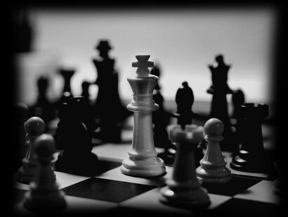 Chess pieces confronting one another like the self-destruction humanity faces if there is no innovation in education