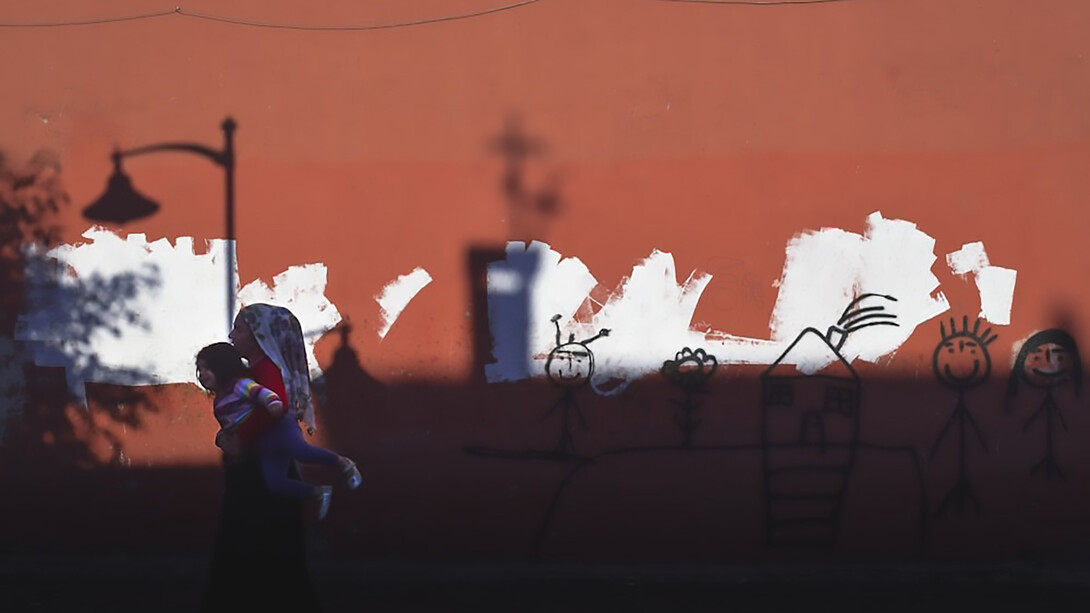 A Syrian refugee carrying child, Istanbul, Turkey