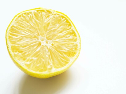 A bright yellow half lemon anticipating the potential from its squeeze