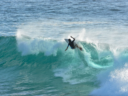 Surfer on big wawes, at Tofo beach, Mozambique