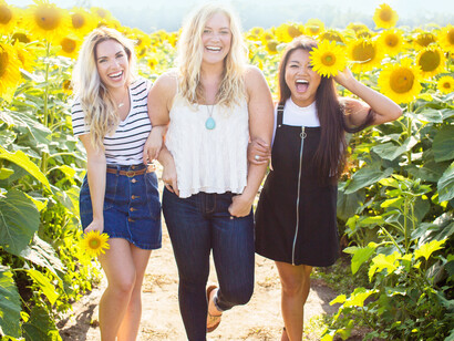 Three girls in the sunflowers; start whistling a song of joy, to cheer up our brothers and sisters as they walk beside each other