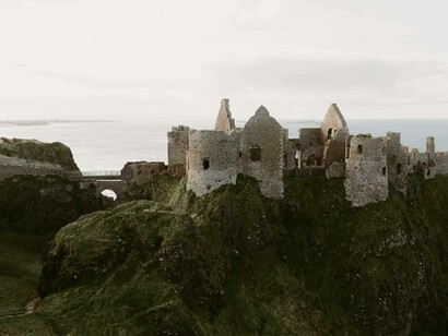 Old medieval ruins of Dunluce Castle on the ocean coast in Northern Ireland 

