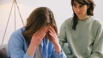 A person trying to deal with their difficult situation in the company of a friend
