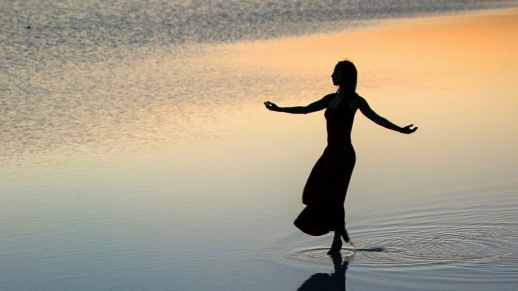 Woman peacefully walking across the water