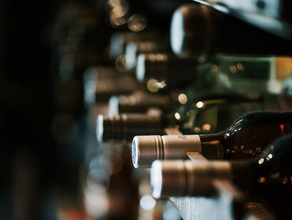 An elegant wine tasting event featuring award-winning wines displayed in a stylish bottle rack