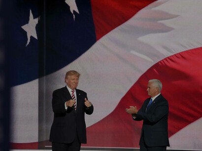 President Donal Trump along with his Vice President, Mike Pence, taking a curtain call in front of the American flag celebrating their version of democracy