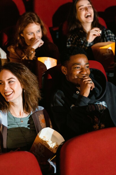 People laugh at a funny scene in the cinema