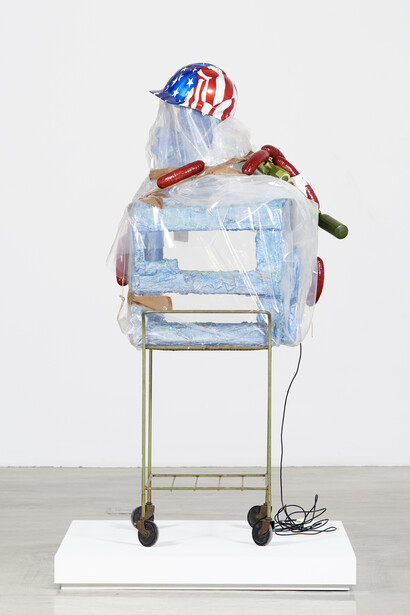 Rachel Harrison © 2004 Hasbro Inc, 2015, wood, cement, acrylic, plastic, tape, pedestal, metal, toy gun, fake sausages, helmet and wheels, 58 x 27 x 28 inches