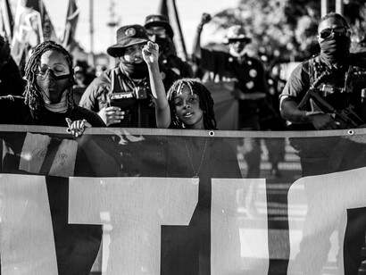 Citizens protesting together while raising fists in solidarity, illustrating the struggle for justice and responsive leadership