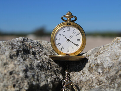 A frozen clock sitting on a rock