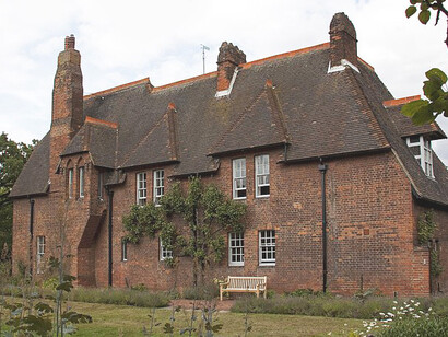 The Red House's interiors feature iconic elements like hand-painted tiles, stained glass by Edward Burne-Jones, and Morris's renowned wallpapers, making the home a living embodiment of artistry, London, England