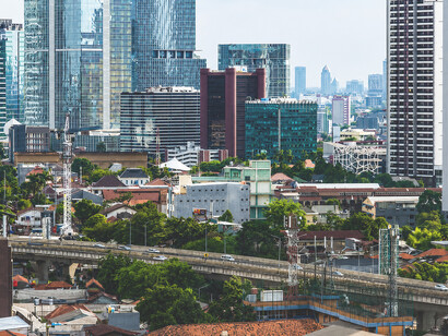 Jakarta’s modern skyline and financial district seen from above, reflecting the contrasts of urban growth and social inequalit