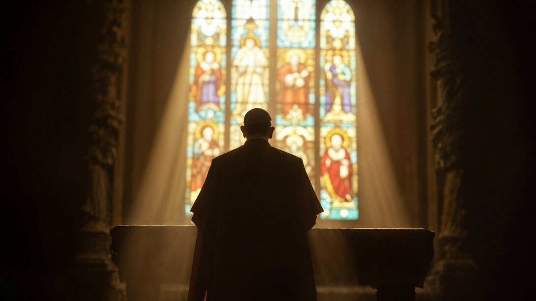 A silhouette bathed in light before the altar, symbolising hope for a church renewed by faith rather than commerce