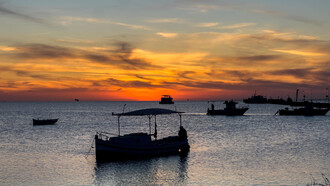 As the sun sets over the island of Kerkannah, Tunisia, the sky becomes a canvas of intense reds and deep oranges, a perfect backdrop for an artist’s reflection, image taken by Pierre Gassin
