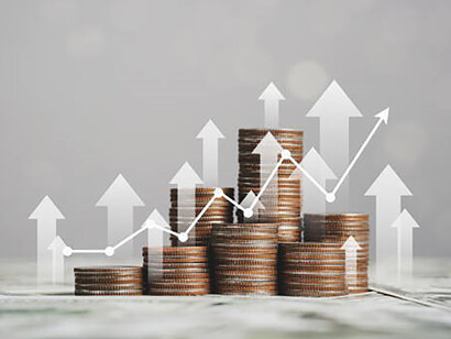 A carefully balanced stack of coins symbolizes the foundation of a robust economy through wise financial investments, driving steady economic growth
