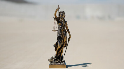 A Lady Justice statue, gracefully holding the scales of justice, symbolizing fairness and equity