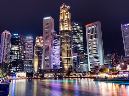 The city of Singapore at night, defined by its modern high-rise architecture