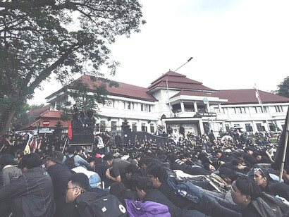 A theatrical protest action of crouching for cover took place in front of Malang City Hall Indonesia