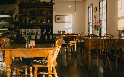 A warm, vintage café interior bathed in natural light, representing the charm and elegance of Japan's traditional kissaten culture