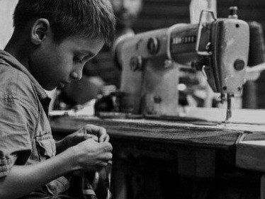 His gaze challenges us to reconsider the true cost of our clothing, each garment carrying the weight of the people who make it, often without proper protections or fair wages