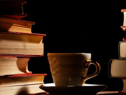 The vintage books are beautifully arranged on the rustic table, creating a charming and inviting atmosphere