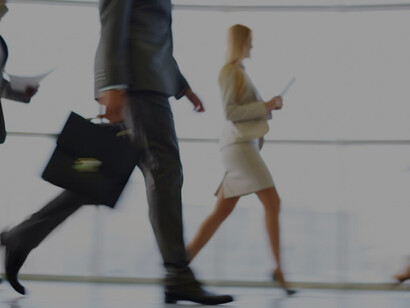 Well-dressed executives in motion, representing the fast-paced dynamics of office life and career progression