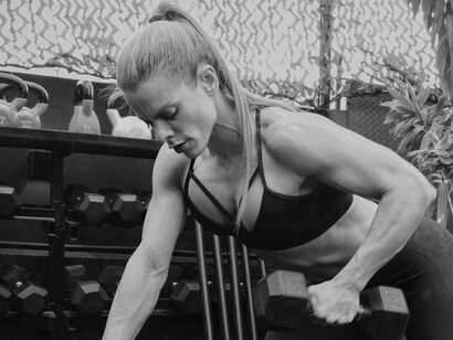 A woman engaged in strength training exercises, building resilience and proving that persistence and dedication lead to powerful results.