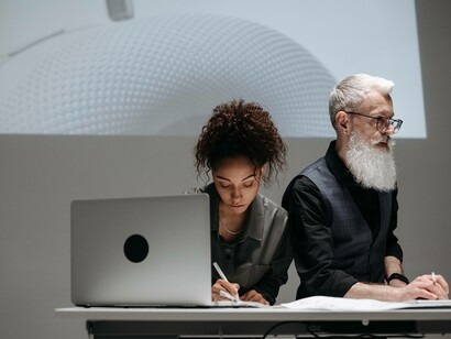 A duo collaborating on a project that involves non-linear innovation