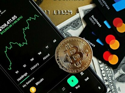 Cryptocurrency and digital payment tools placed beside traditional currency, representing the intersection of decentralised finance and mainstream banking