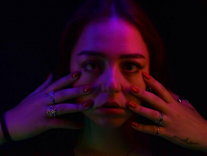 A woman caught in the darkness, reflecting the restless uncertainty of social comparison