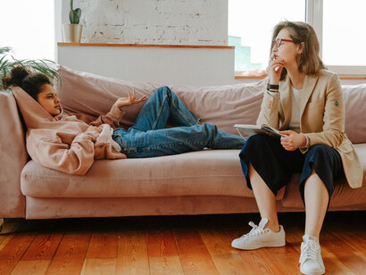 Young woman speaking with a therapist, illustrating teenage mental health, an overwhelmed teenager, and a stressed teen girl