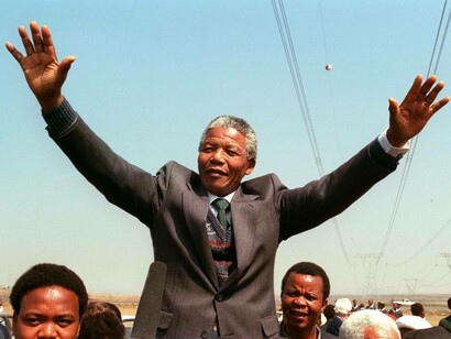 Nelson Mandela with hands in the air as he greets the crowd in Port Elizabeth on April 1, 1990