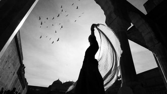 A woman dancing as birds fly in the background, reflecting the self-expression and freedom the art form brings
