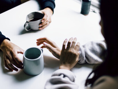 Man and a woman talking over coffee
