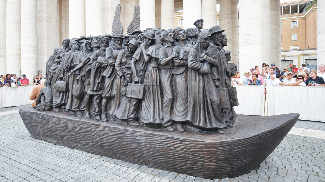 “Angels Unaware” sculpture, depicts 140 migrants and refugees from various historical periods traveling on a boat, and includes indigenous people, the Virgin Mary and Joseph, Jews fleeing from Nazi Germany, and those from war-torn countries. Displayed in St. Peters Square