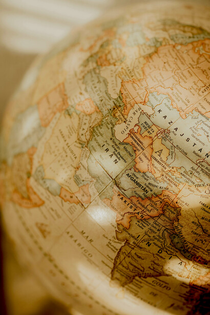 A vintage-style globe highlighting the regions of South Asia and Europe