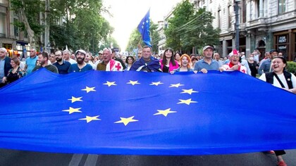 Demonstrators carry a giant EU flag during an anti-government rally near the Georgian Parliament in Tbilisi