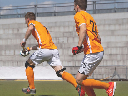 Field hockey players competing in an intense tournament game