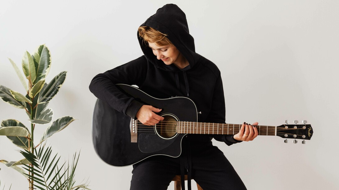 Person playing the acoustic guitar