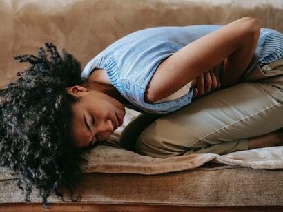 A woman experiencing a dip in health and needs attention from the World Health Organization
