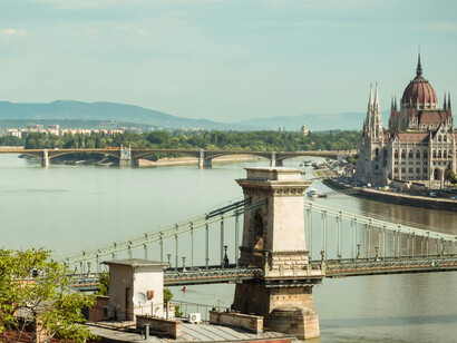 Brown and white architecture rising beside the Danube River in Budapest, capturing the city’s historic waterfront and riverside atmosphere, Budapest, Hungary