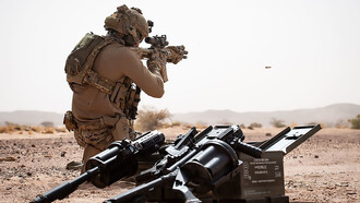 A French special forces operator from Task Force Takuba in the Sahel, with a Milkor Multiple Grenade Launcher visible in the foreground (2 June 2022)