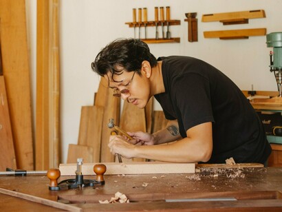A woodworker refining his craft with precision, reflecting the patience needed to turn vision into reality