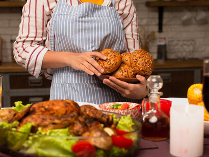 A woman holding bread and turkey 