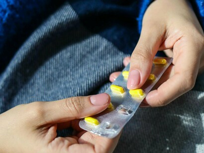 A sick patient separating their medicine, another technology that requires years of research to be made