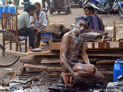 Boy washing himself in the slums